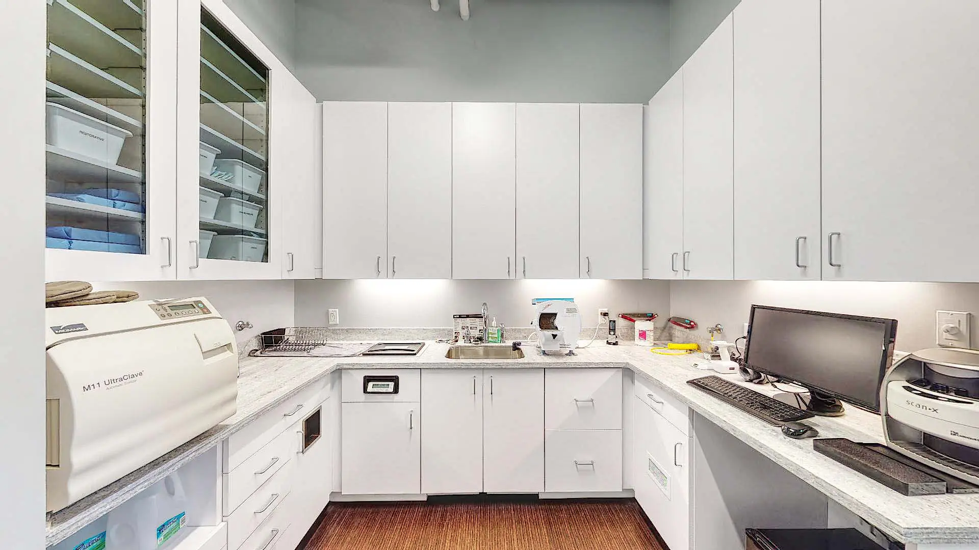 Dental sterilization room with white cabinets