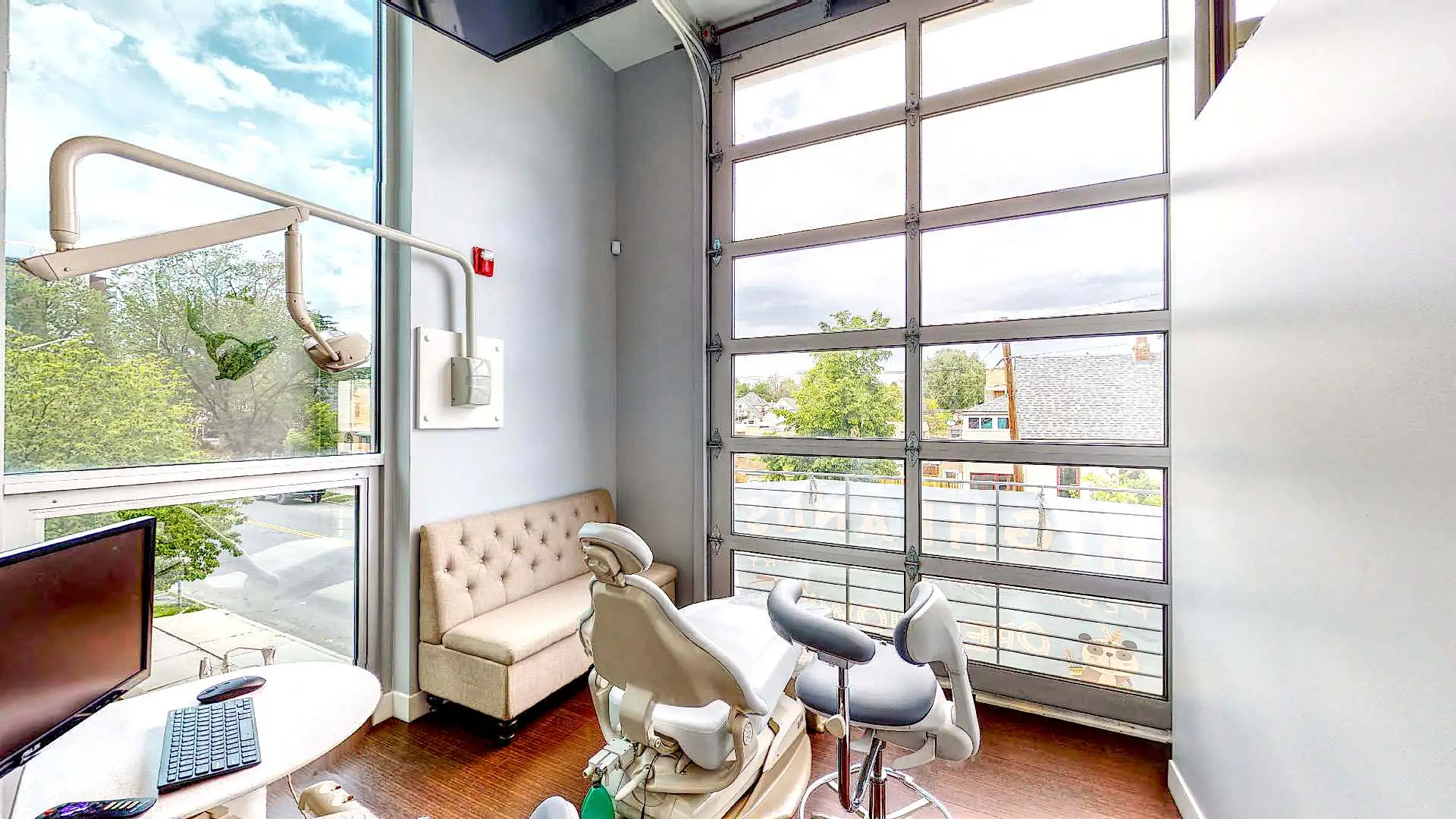 Modern dental exam room with large glass door